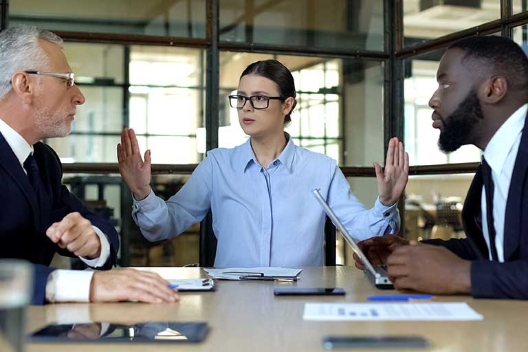 A person stopping an argument in a meeting