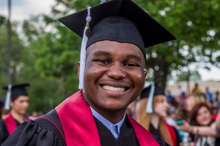 A joyful graduate at Commencement