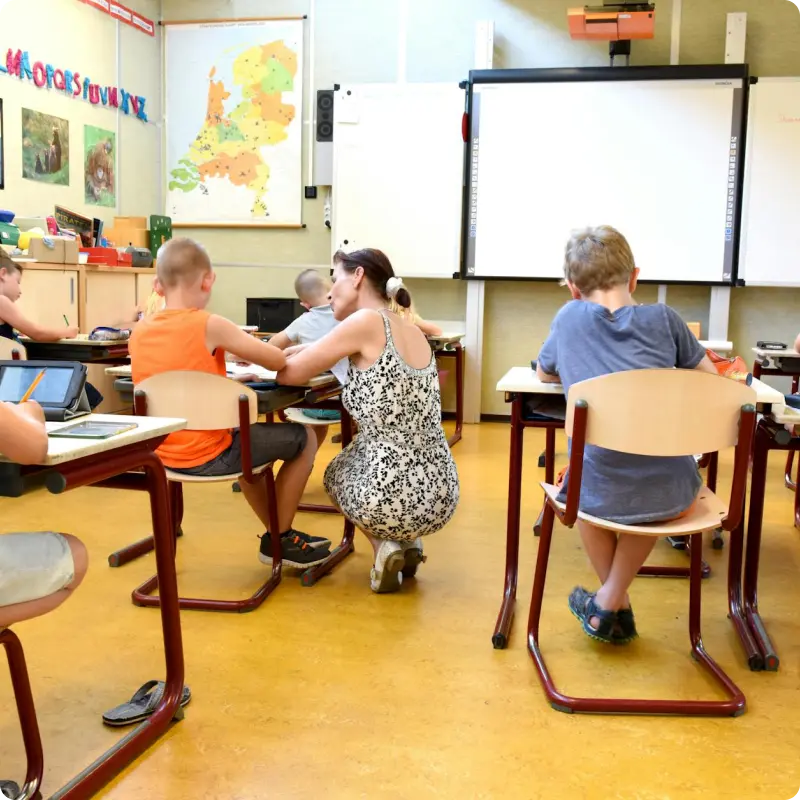 Instructor helping a young student in a classroom