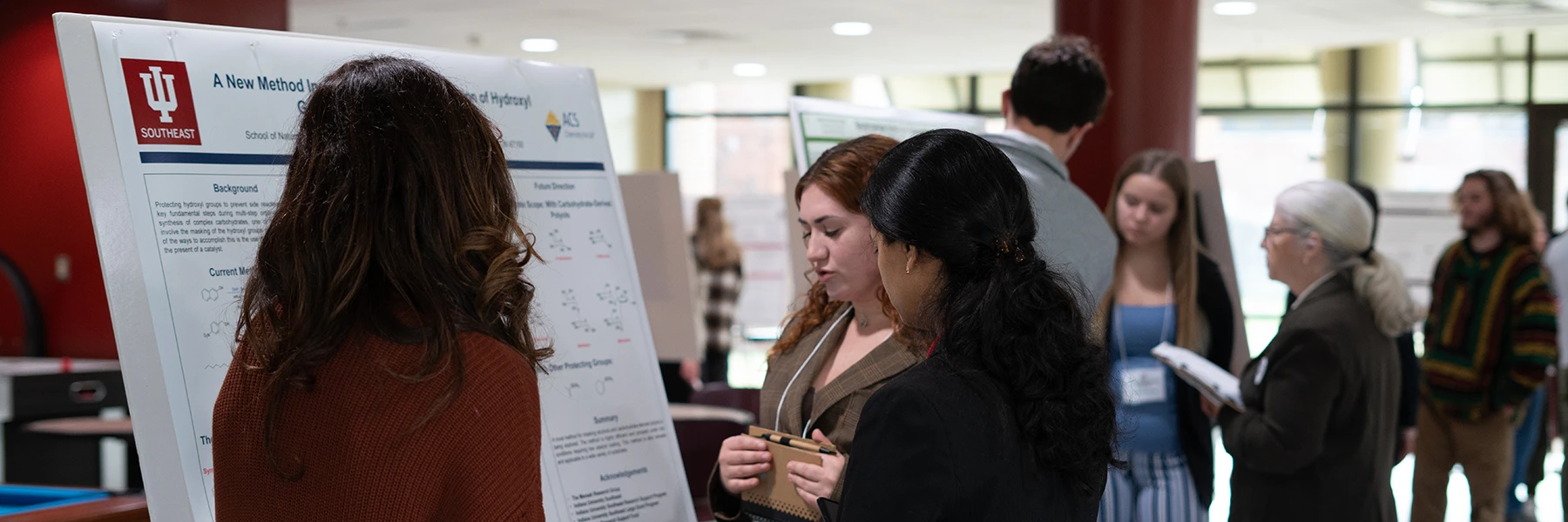 IU Southeast students looking at a poster presentation